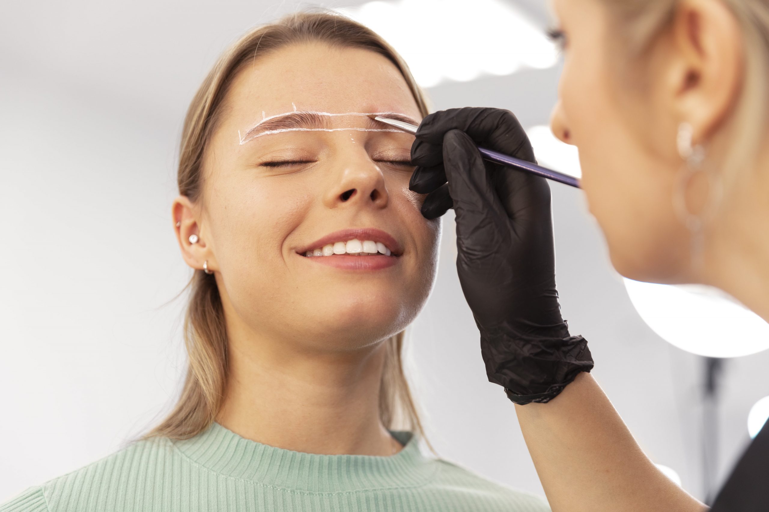 young woman going through microblading scaled
