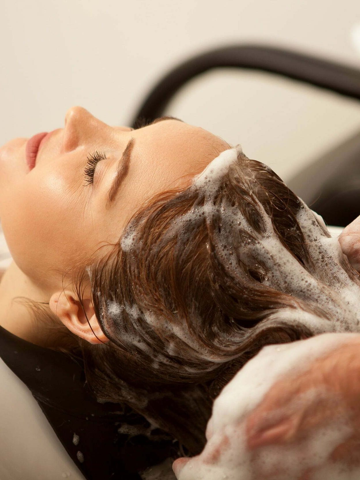 gorgeous-woman-having-her-hair-washed-by-hairdresser-