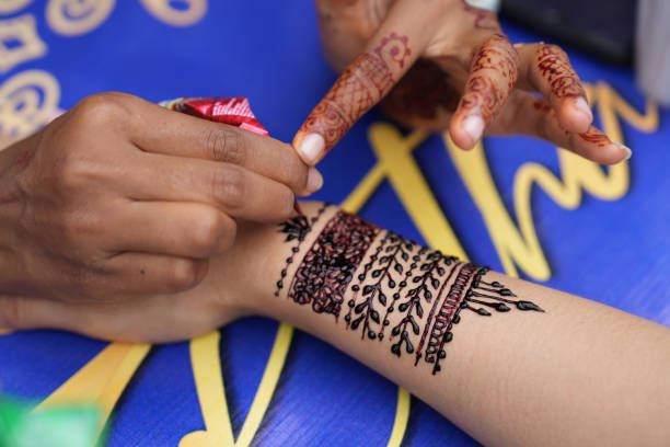 Artist Applying Henna Tattoo